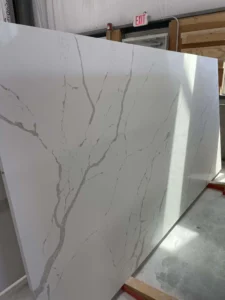 White marble slab with gray veining for countertops or surfaces.