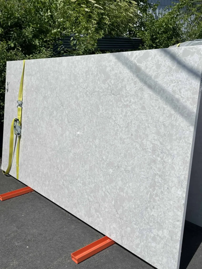 White marble slab for countertops or flooring, displayed outdoors.