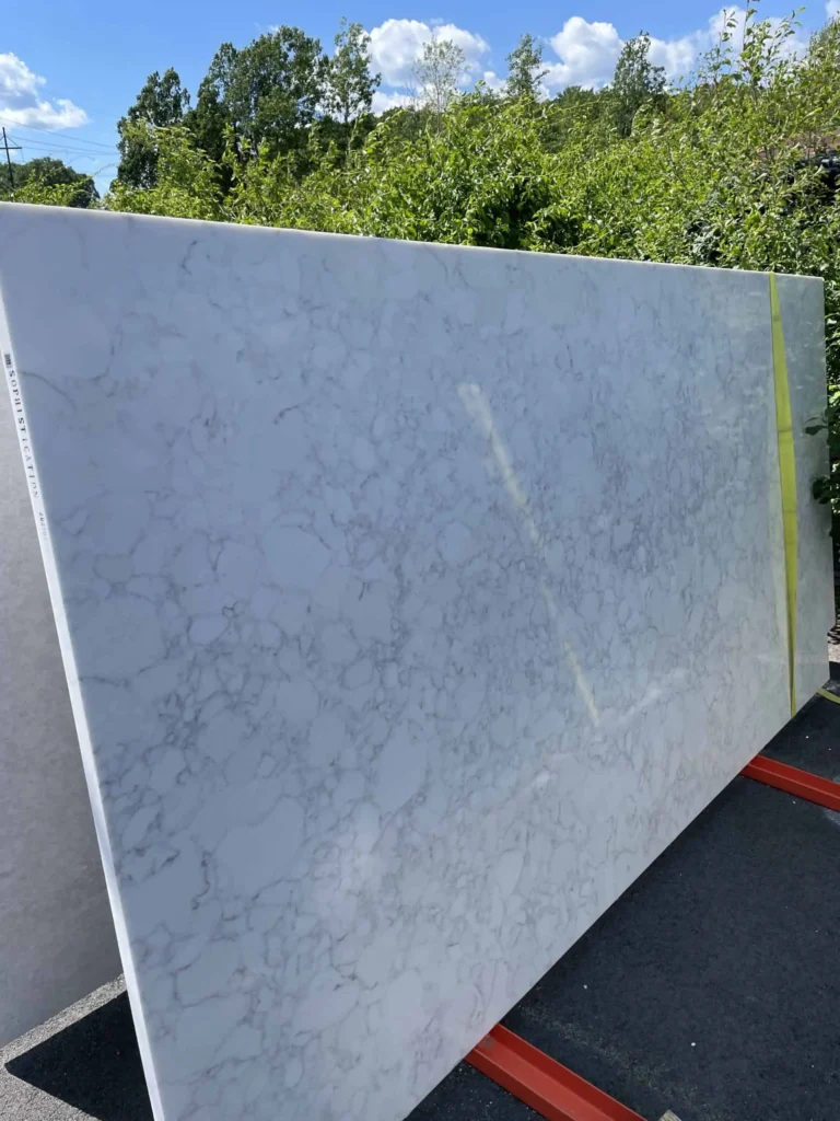 Large white marble slab with gray veining for countertops or surfaces.